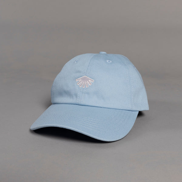 Light blue baseball cap with a small logo on a gray background