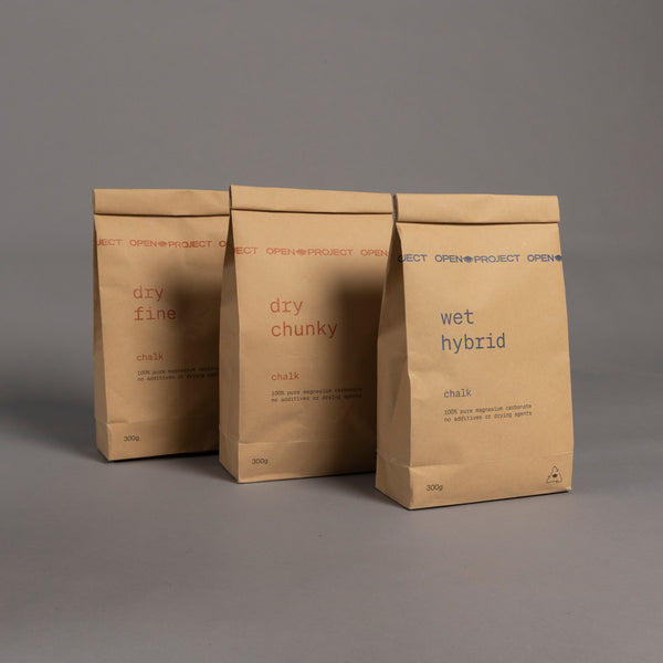 Three brown paper bags labeled 'dry fine', 'dry chunky', and 'wet hybrid' on a gray background.