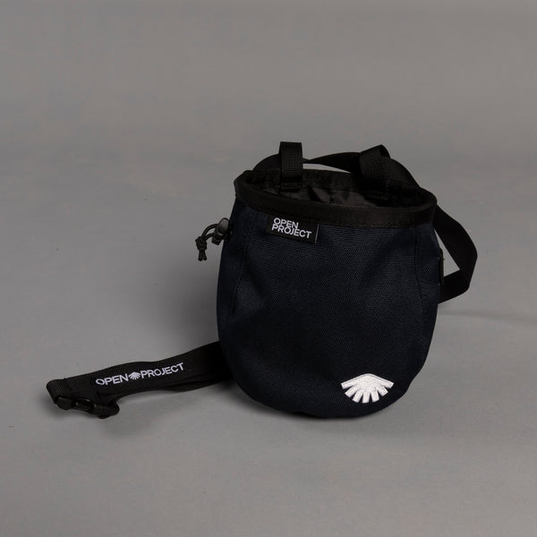 Navy chalk bag with 'Open Project' branding on a gray background