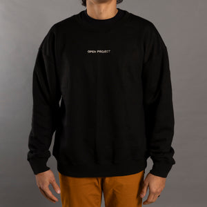 Man wearing a black sweatshirt with 'Open Project' logo on a gray background