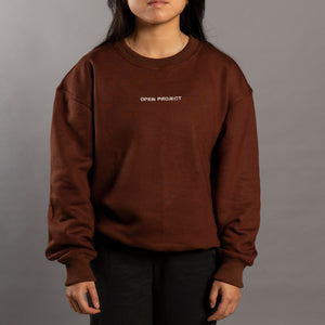 Person wearing a brown sweatshirt with 'Open Project' text on a gray background