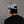 Person wearing a light blue cap with a brand logo on the back against a gray background