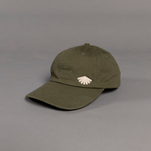 Green cap with a white logo on a gray background