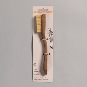 Wooden climbing brush with natural bristles on a gray background, featuring 'Open Project' branding.