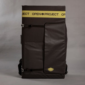 Black crash pad with yellow branding on a gray background