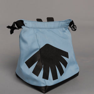 Light blue boulder bag with black design on a gray background