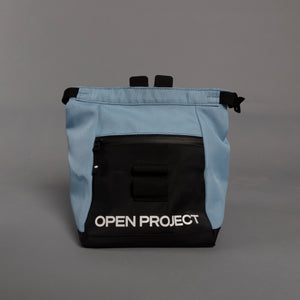 Light blue and black boulder bag with 'Open Project' branding on a gray background