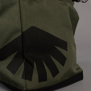 Green boulder bag with black logo on a gray background