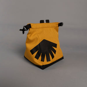 Yellow boulder bag with black design on a gray background