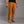 Person wearing mustard yellow climbing pants on a gray background