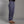 Person wearing blue climbing pants on a gray background