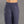 Navy blue climbing pants on a gray background
