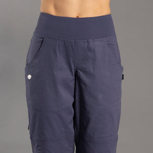 Navy blue climbing pants on a gray background