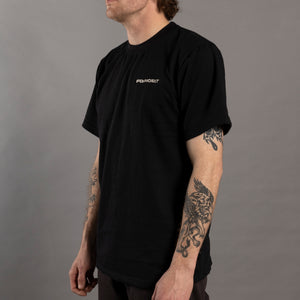 Person wearing a black t-shirt with a logo on a gray background