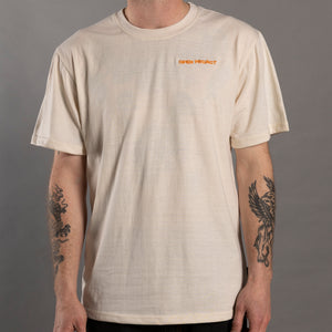 Person wearing a beige t-shirt with a logo on a gray background