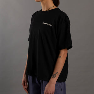 Person wearing a black t-shirt with 'OPEN PROJECT' logo on a gray background