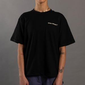Person wearing a black t-shirt with 'Open Project' logo on a gray background