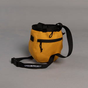 Yellow bag with black strap and 'Open Project' branding on a gray background